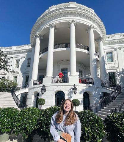Female Student in Front of White House Porch