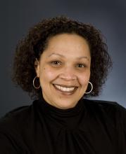 woman of color smiling in headshot