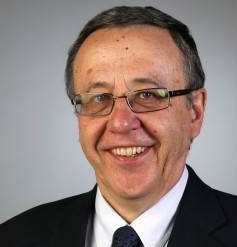 man in glasses smiling at camera