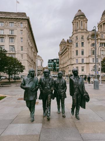 Bronze statues of the four Beatles members walking in Liverpool