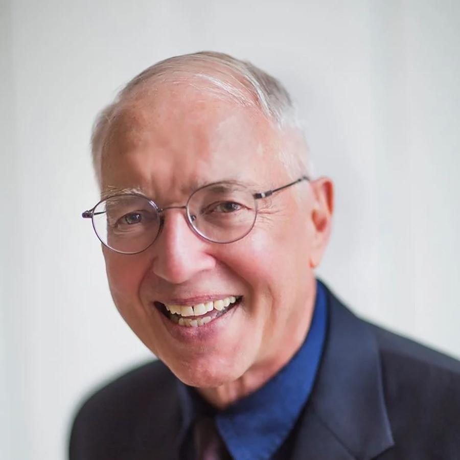 man in glasses smiling at camera