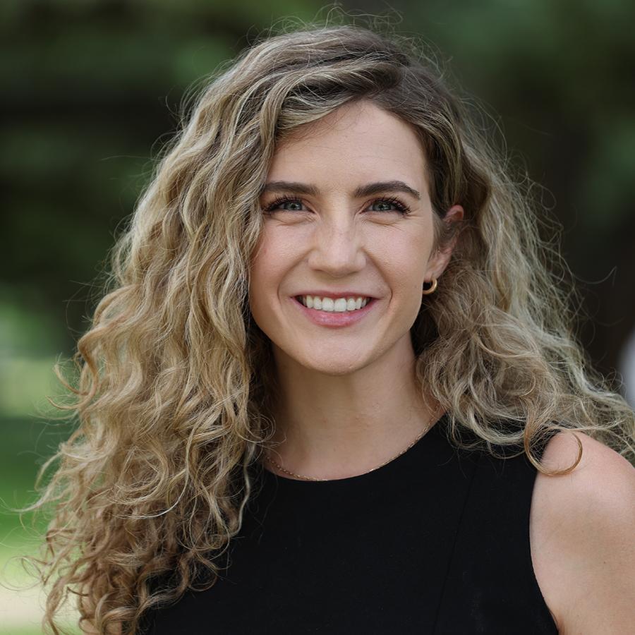 young woman with curly hair smiling