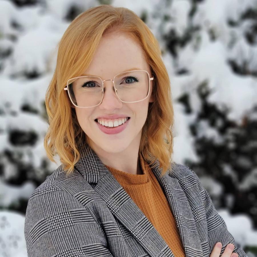 Woman in glasses smiling at the camera