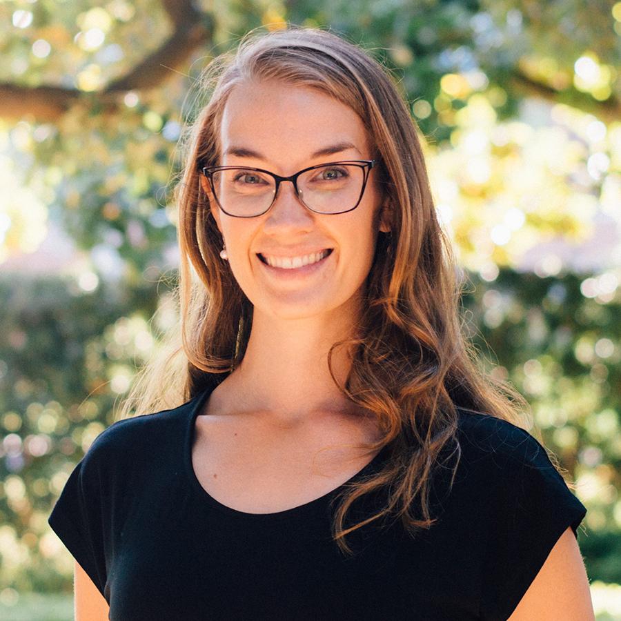 woman in glasses smiling at camera