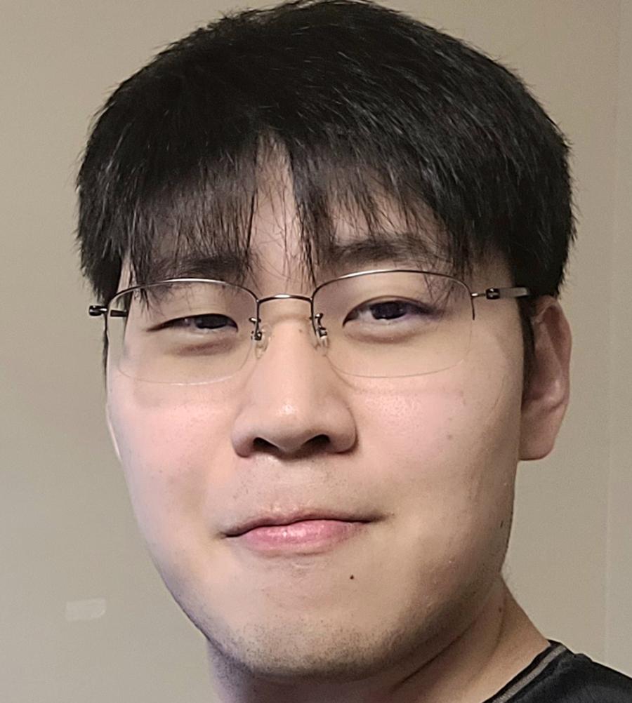 man in glasses smiling at camera