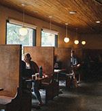 Pinewood interior shot of wooden booths and windows,