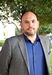 Dr. Joao Chaves faces the camera with a serious expression