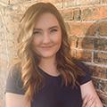 Savannah Flanagan wears a black t-shirt and faces the camera smiling