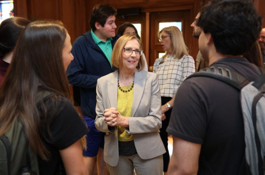 Photo of Provost Nancy Brickhouse smiling and talking to people.